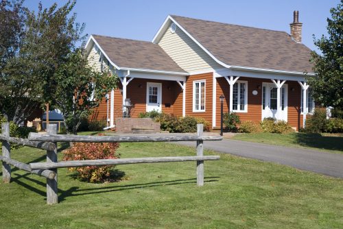 A,Rustic,Pole,Fence,Next,To,A,Small,Family,Home